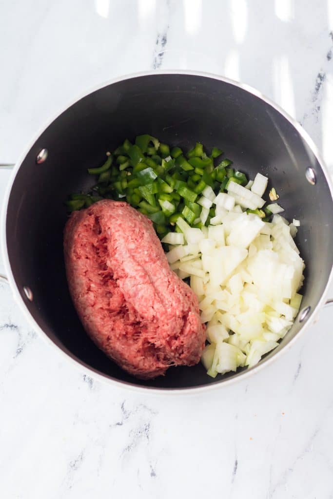 ground beef, diced peppers and onions in a large silver pot