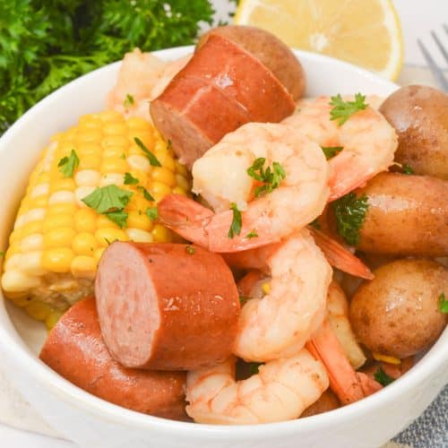 slow cooker shrimp boil piled high in a small white bowl
