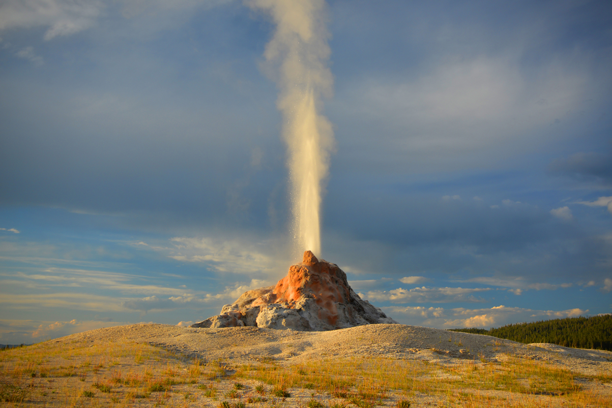 White Dome Geyser Erupts Straight Up From Its Massive Grotto At Sunset