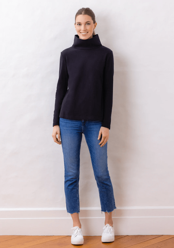 woman in black turtleneck and blue jeans.