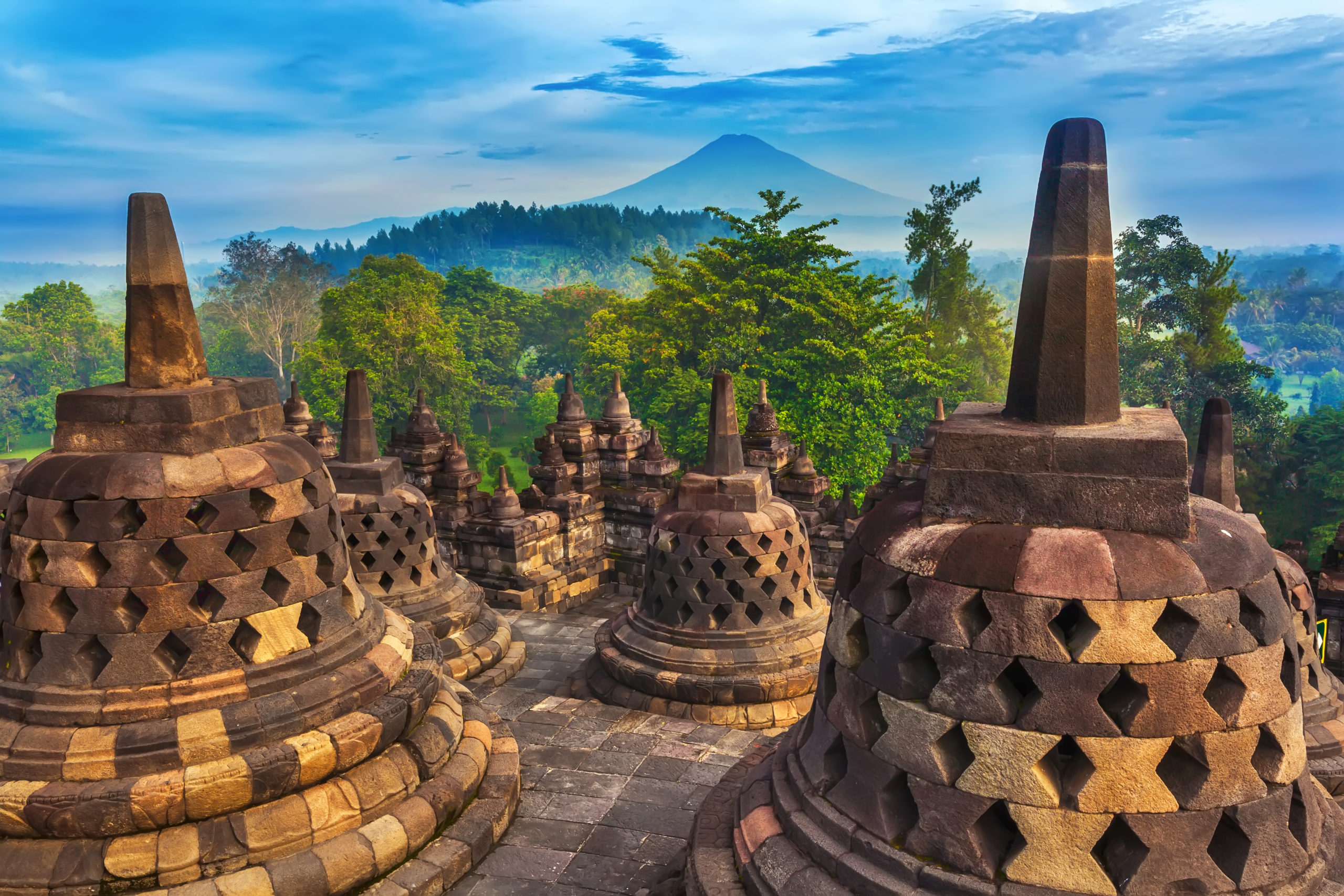 Candi Borobudur in the background of rainforest, morning mist and