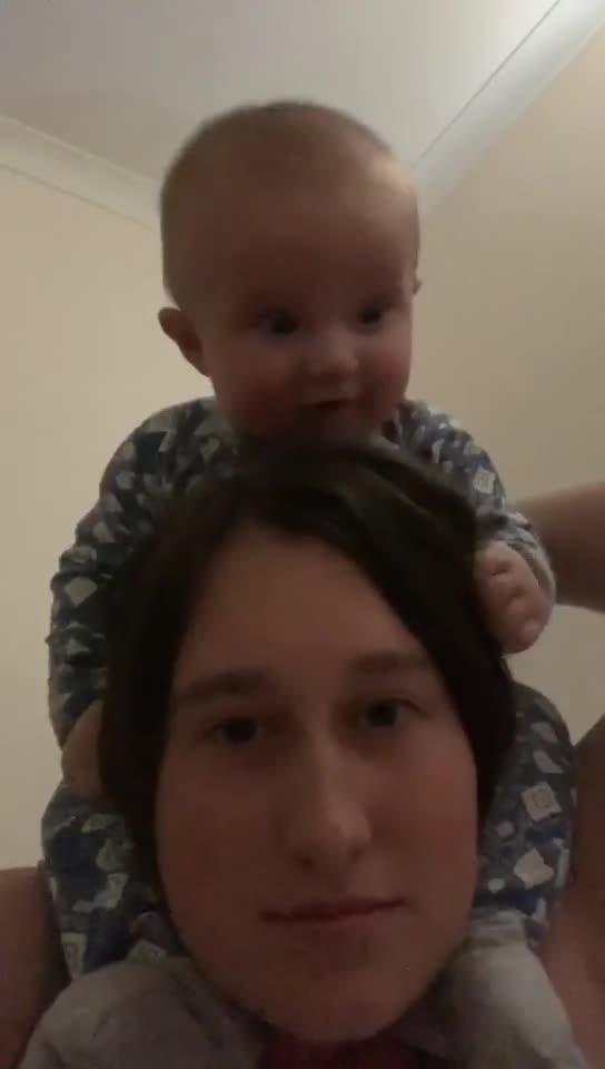 Baby Pukes on Mom's Head While Sitting on her Shoulders Jukin Licensing