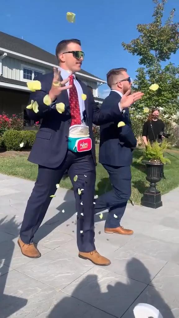 Flower Guy at Wedding Strews Petals From Fanny Packs as He Struts Down