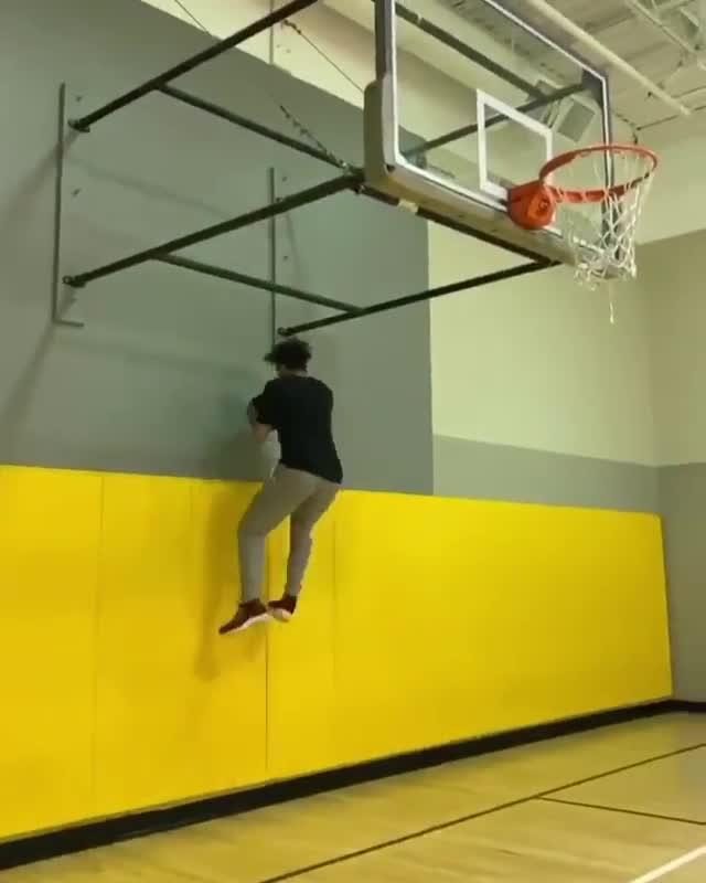 Guy Shoots Basketball into Hoop With His Back Turned Opposite to It