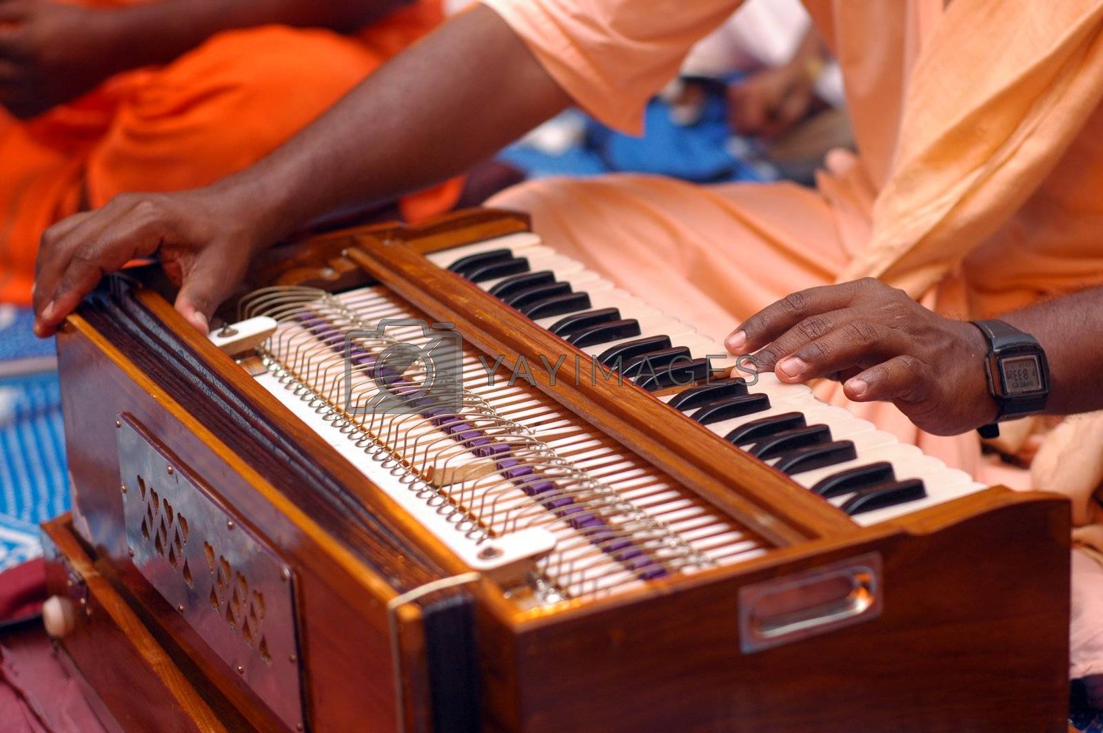 Royalty Free Image Krishna Devotee Playing Harmonium by ngothyeaun