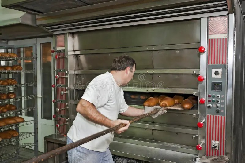 Making Bread in Bakery. Uncooked Bread Dough on a Rack Ready for Baking