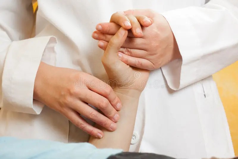 Checking a patients pulse stock image. Image of treating