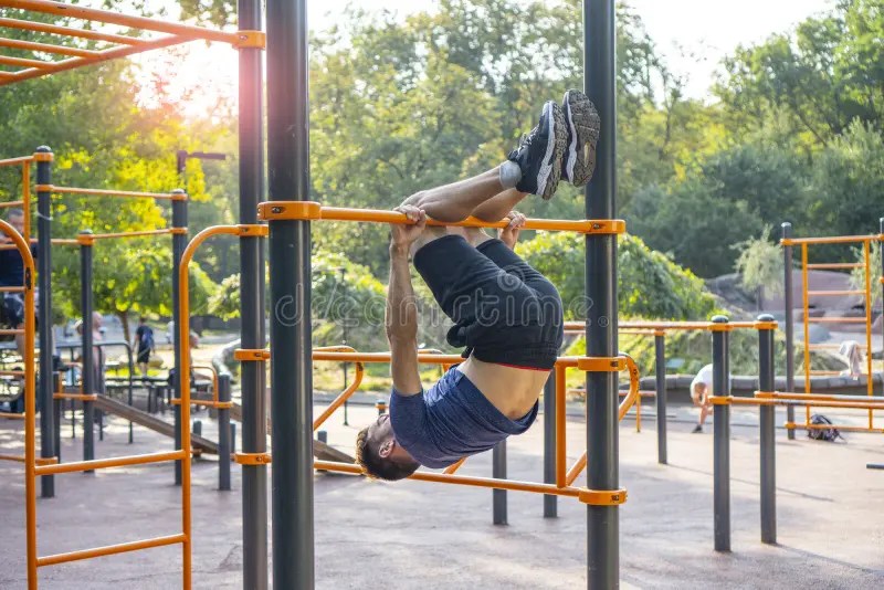Performing Acrobatic Exercises on the Horizontal Bar. Stock Image
