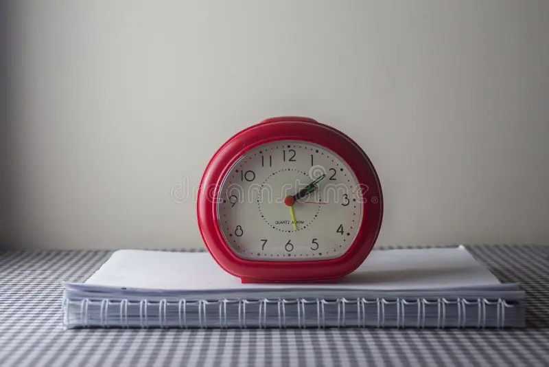 Small Red Clock on the Notepad on the Table Stock Photo Image of