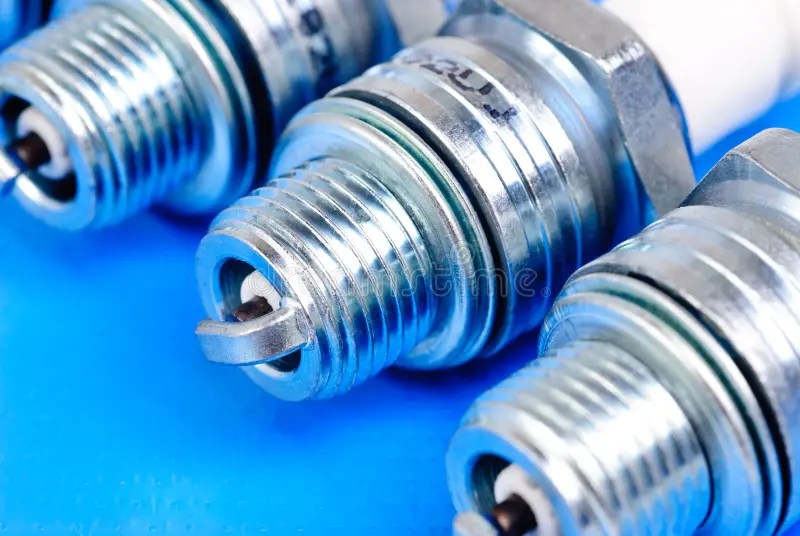 Sparkplug on the red stock image. Image of industrial 22079301