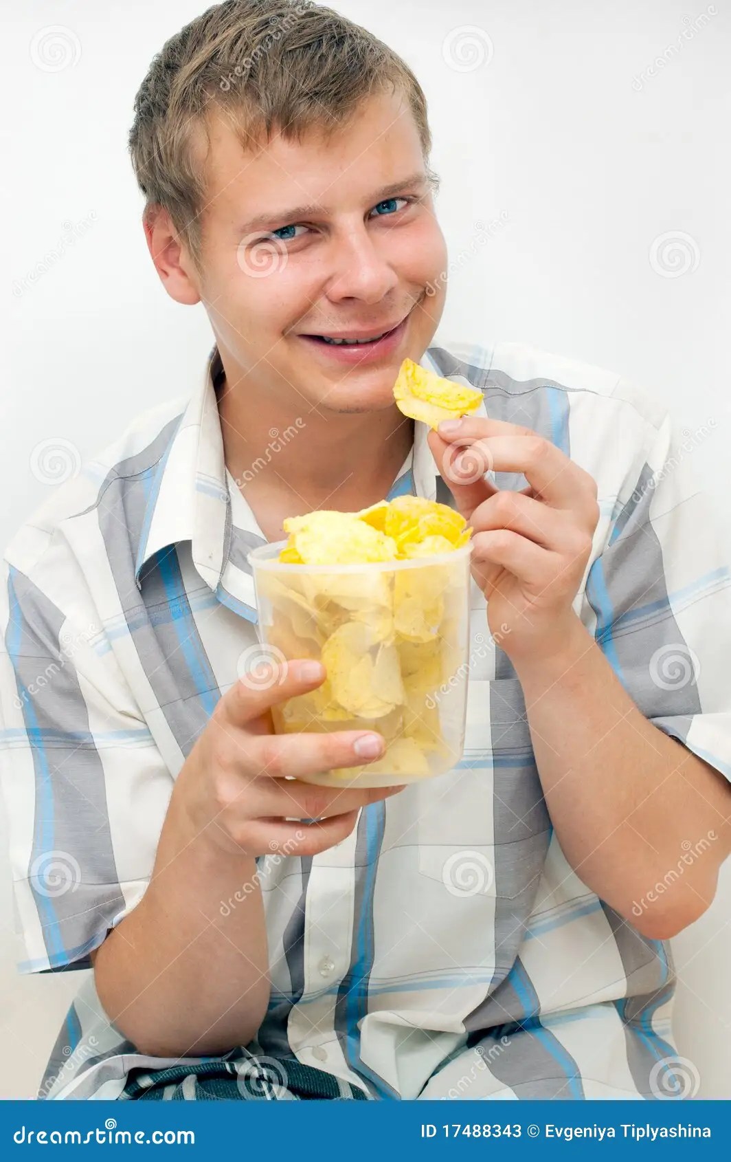 The guy eats chips stock image. Image of sustenance, male 17488343