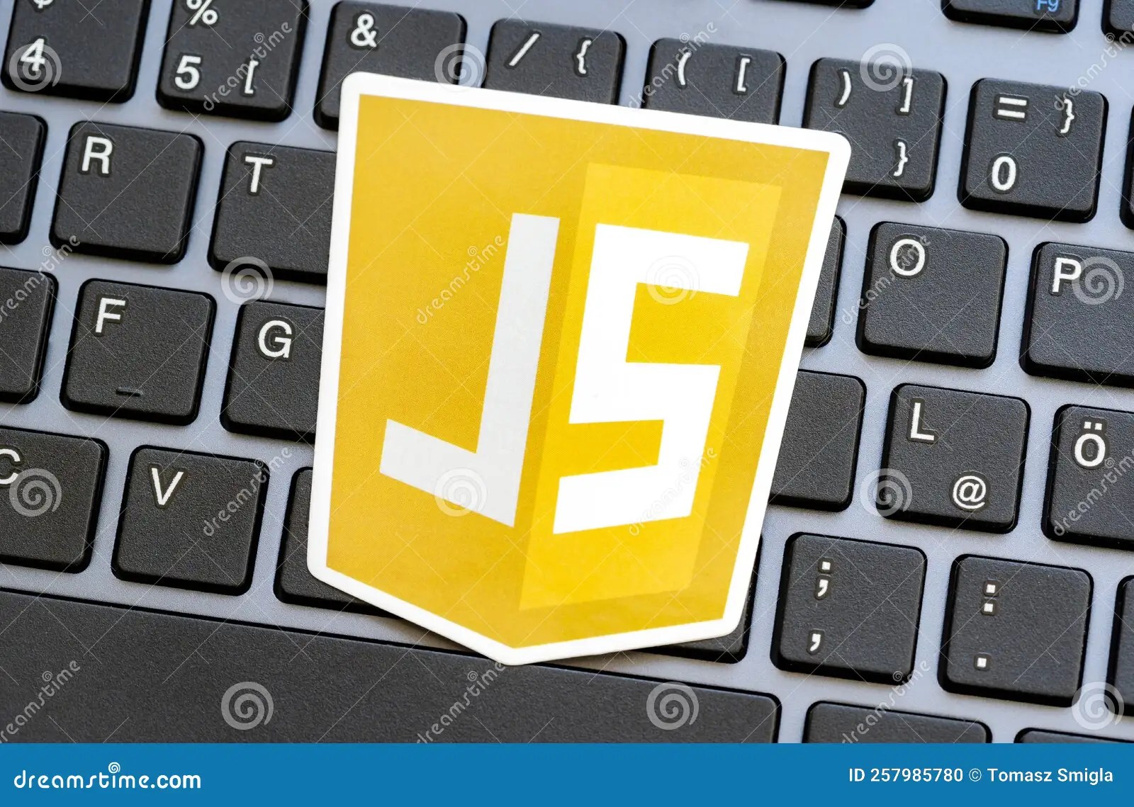 JS, JavaScript Programming Language Logo Laying on a Modern Computer