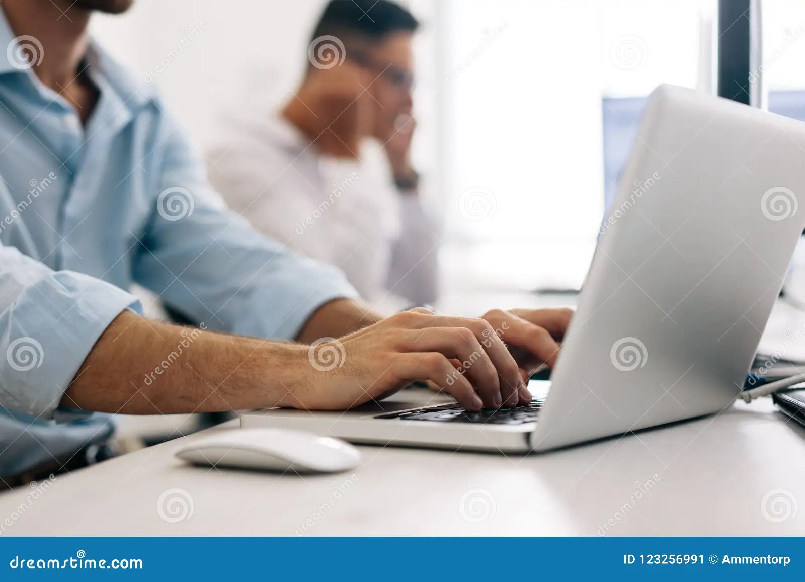 Application Developers Working On Computers In Office