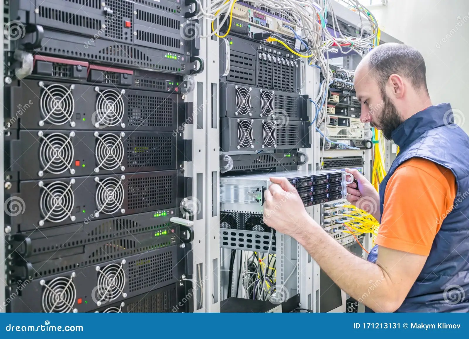 System Administrator Installs A New Server In A Modern Data Center. The