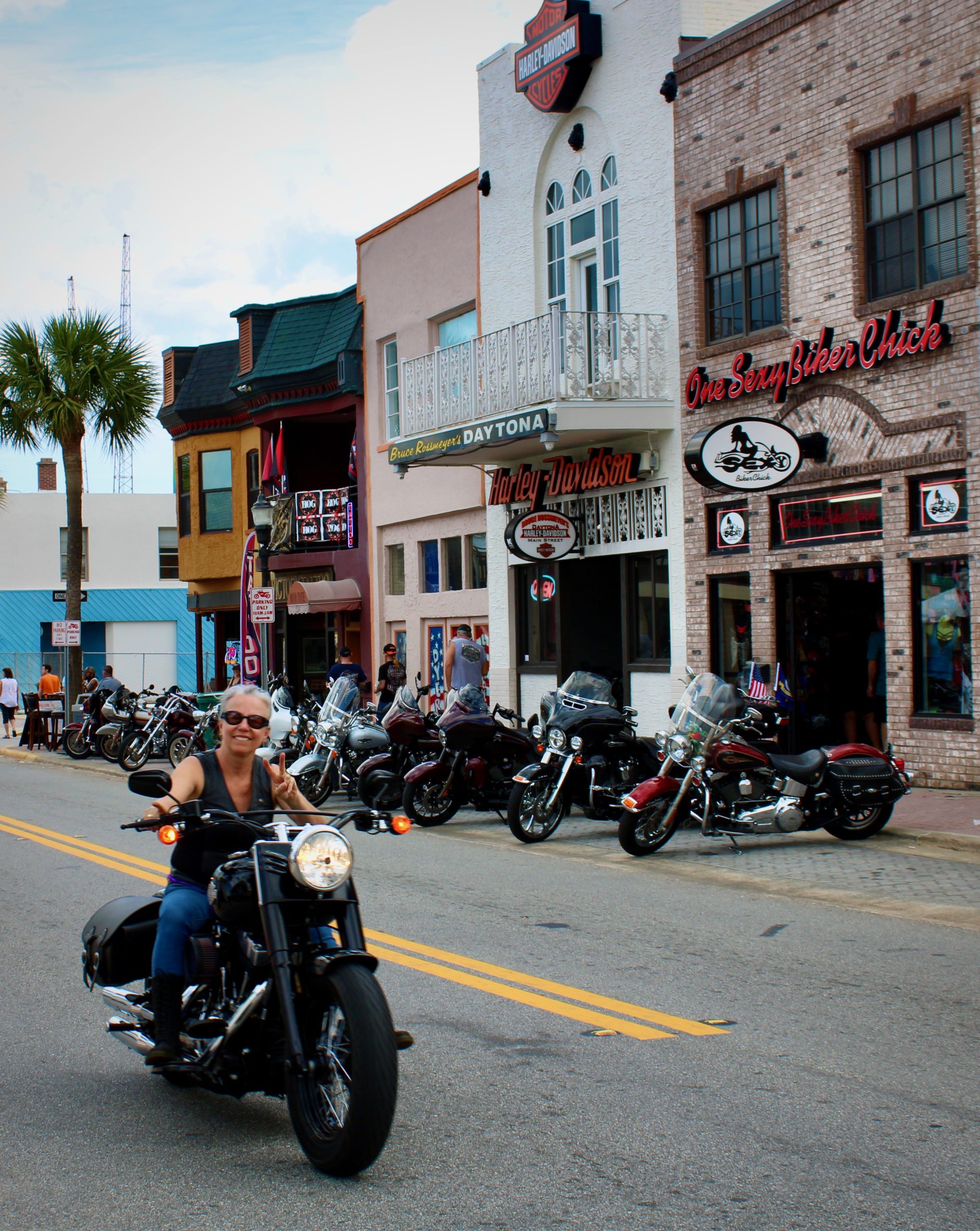 Female biker cruises down Main Street at Daytona Bike Week 2020.