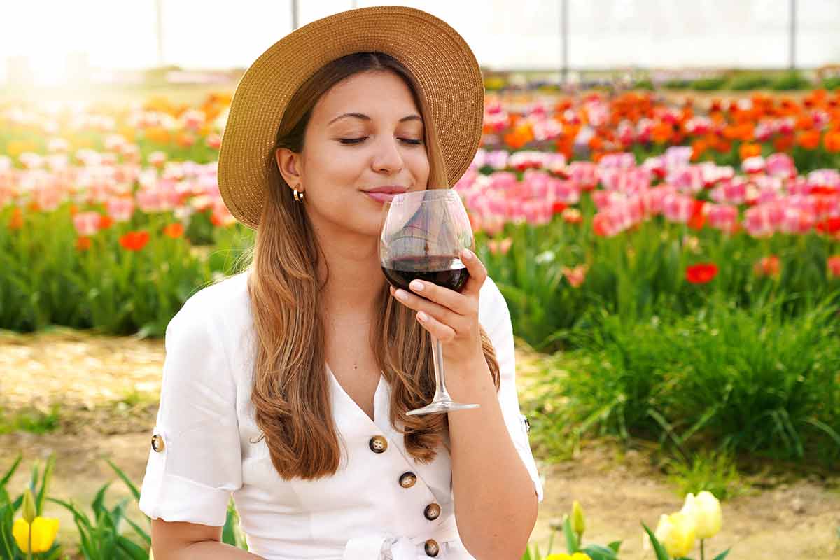 italian drinks a woman drinking red wine with closed eyes in a garden
