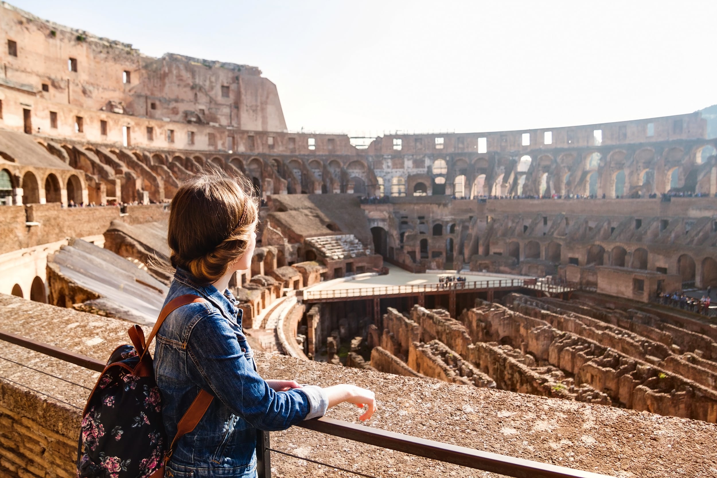 Young girl with backpack exploring inside the Colosseum (Coliseum