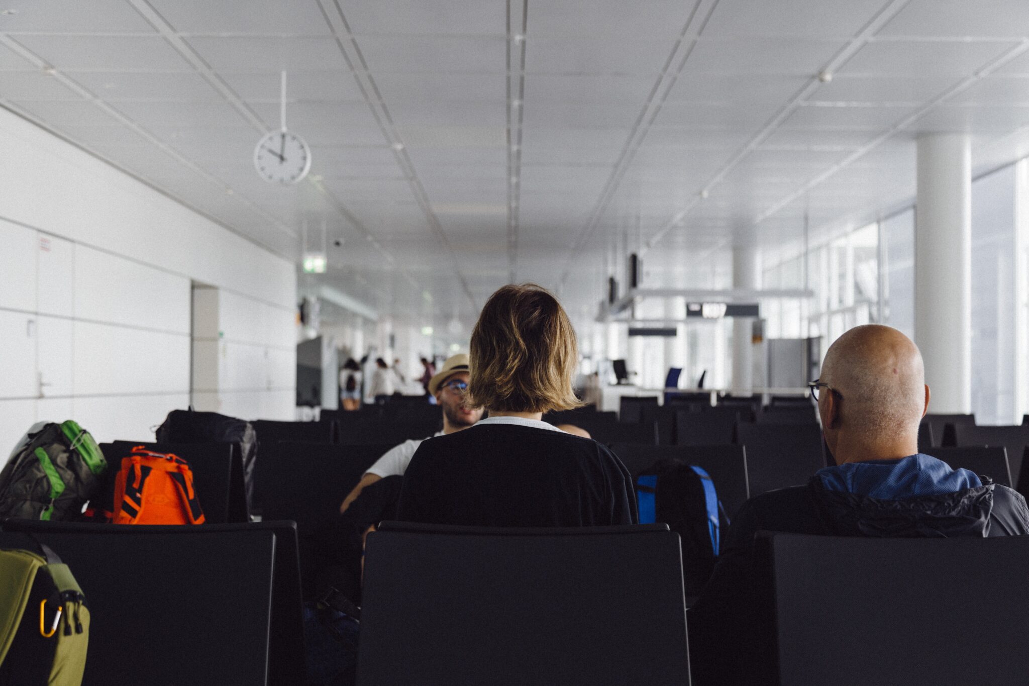People waiting to fly in an airport departure lounge