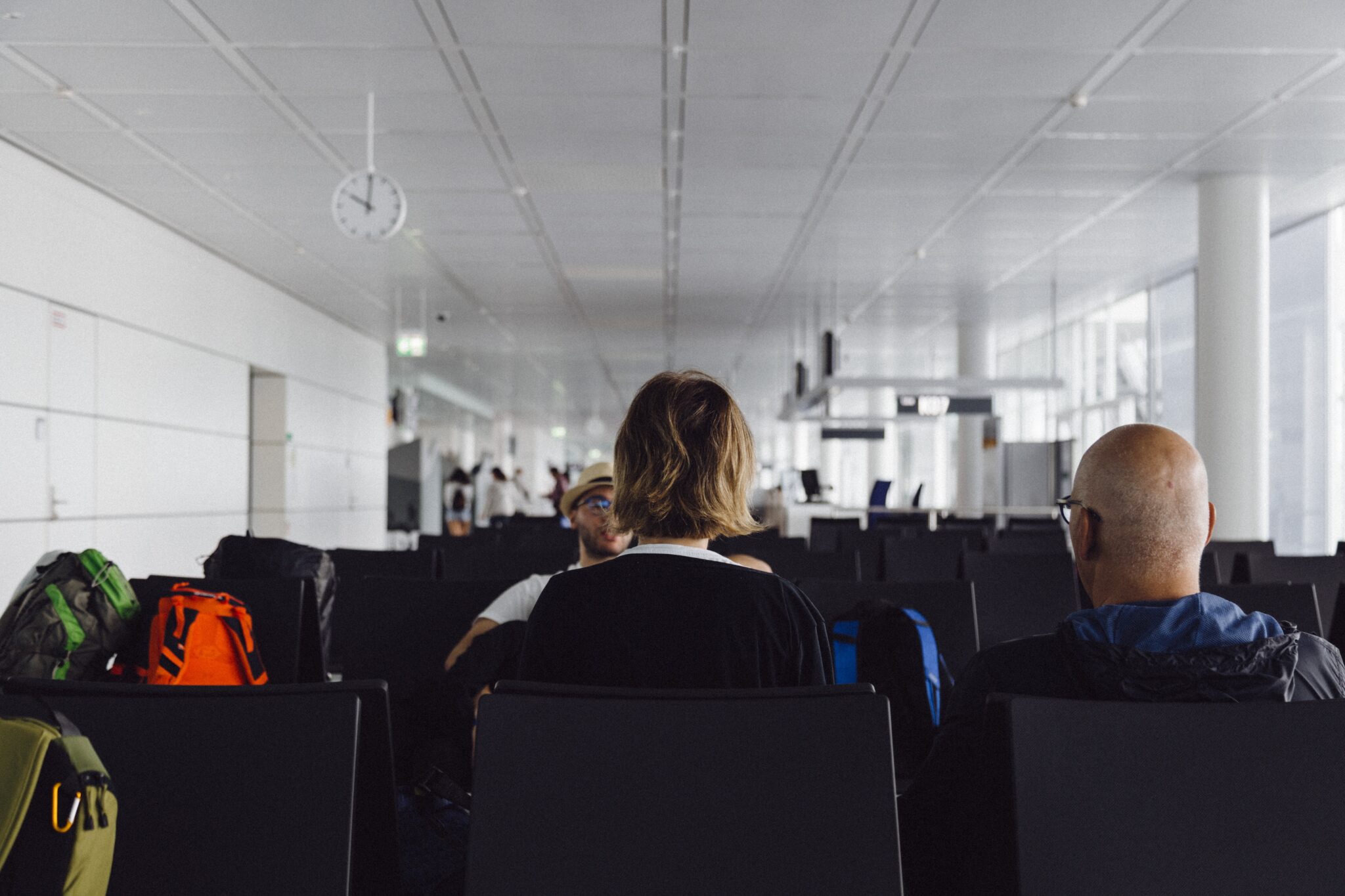 People waiting to fly in an airport departure lounge