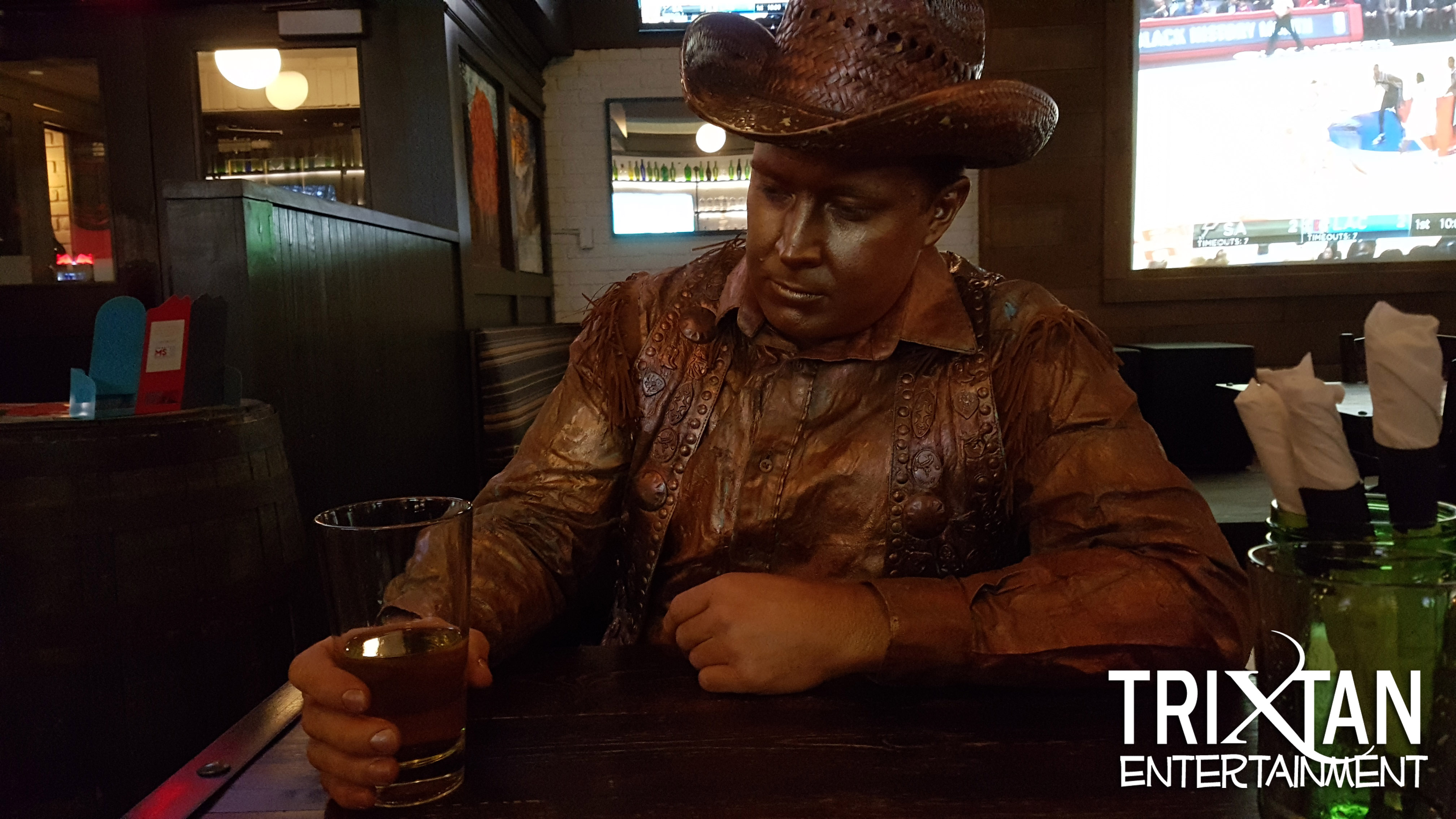Copper Cowboy Holding a Beer TriXtan Entertainment inc.