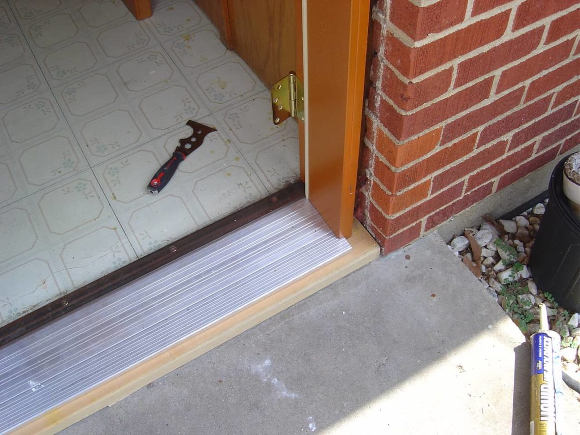 How do I fill the gap under my front door threshold?