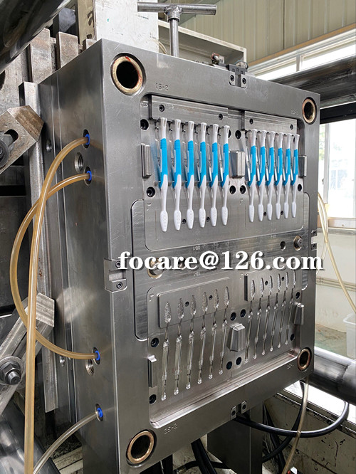 Two component multi cavity toothbrush mold with rotary shaft design