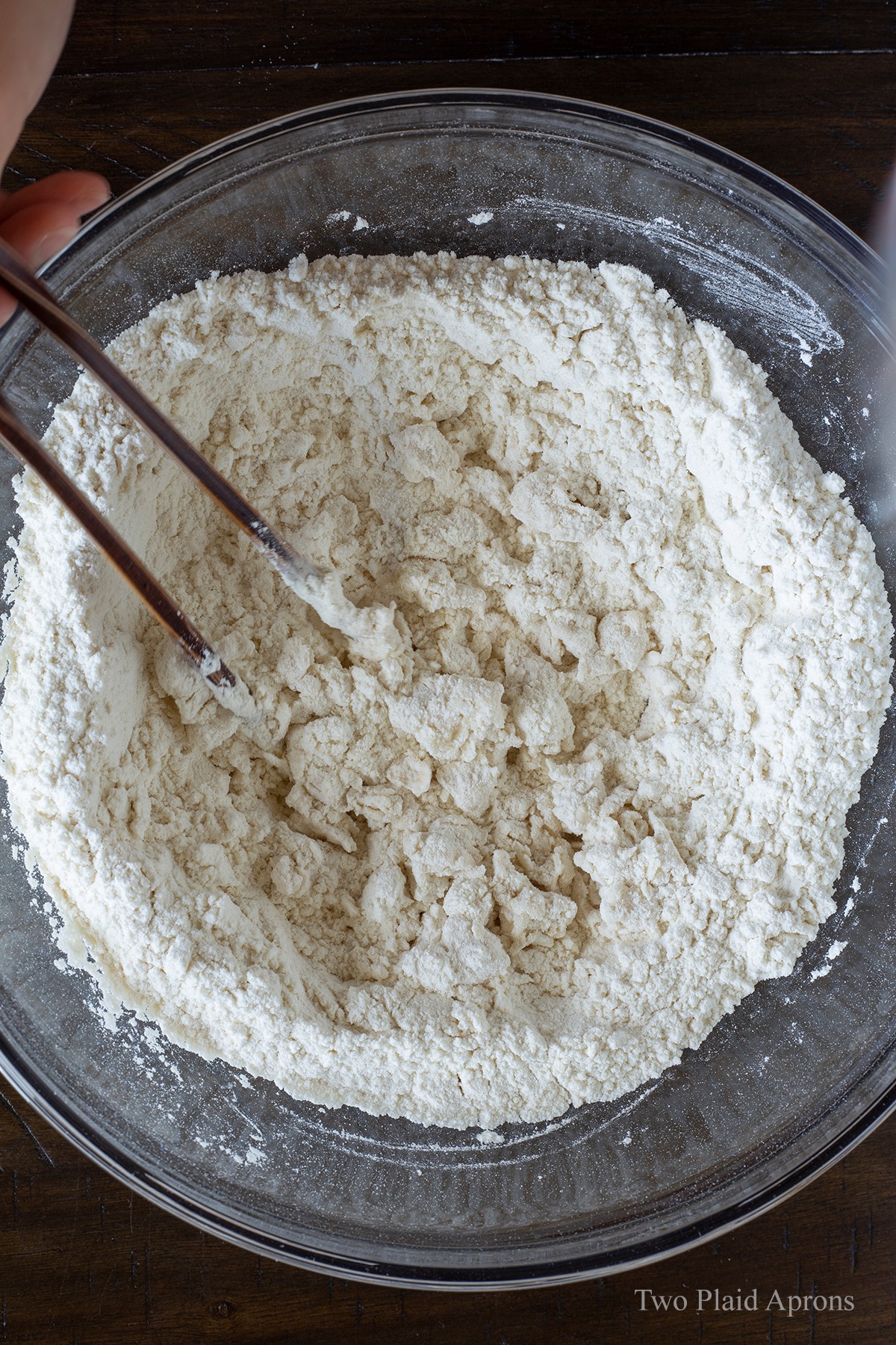 Stirring the flour while adding liquid.