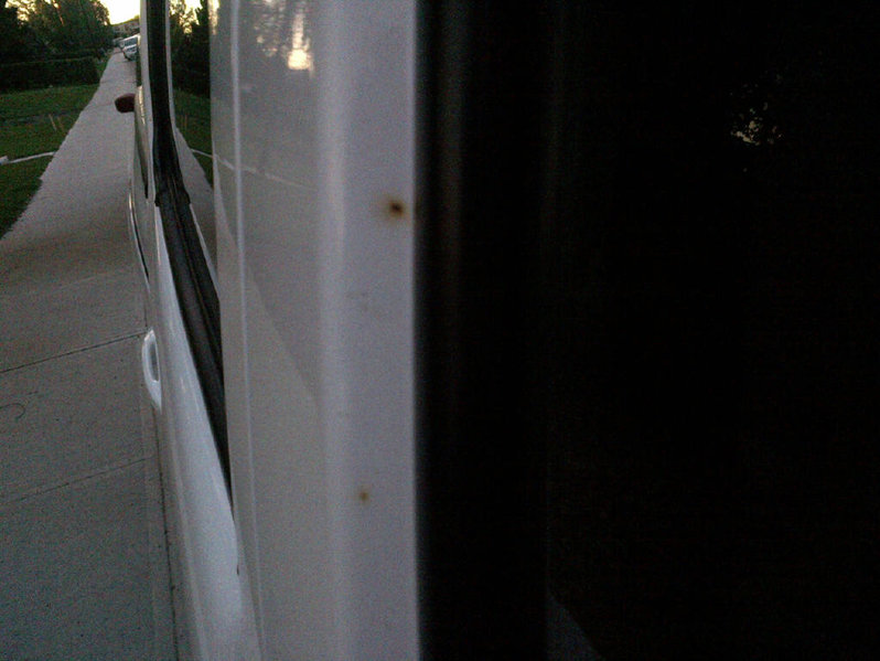 Rust coming through white paint around windows World