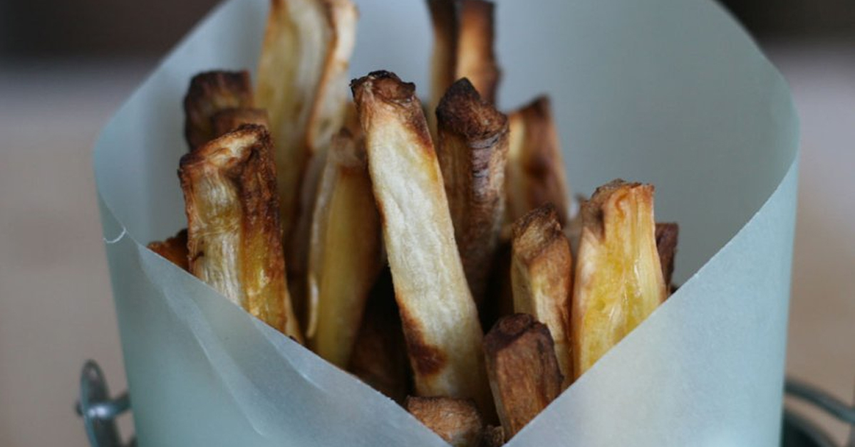 A container of parsnip fries ready to be eaten.