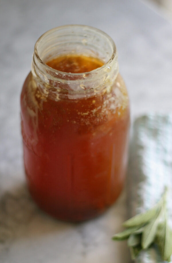 A glass jar filled with bone broth.