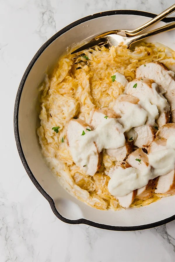 A Dutch oven filled with spaghetti squash chicken alfredo after done cooking.