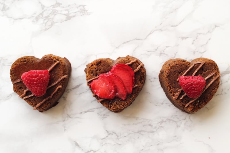 AIP Brownies in heart shapes with icing and strawberries.
