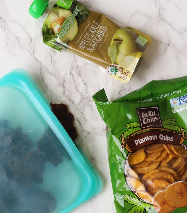 A bag of plantain chips, a packet of baby food and a stasher bag filled with beef jerky.