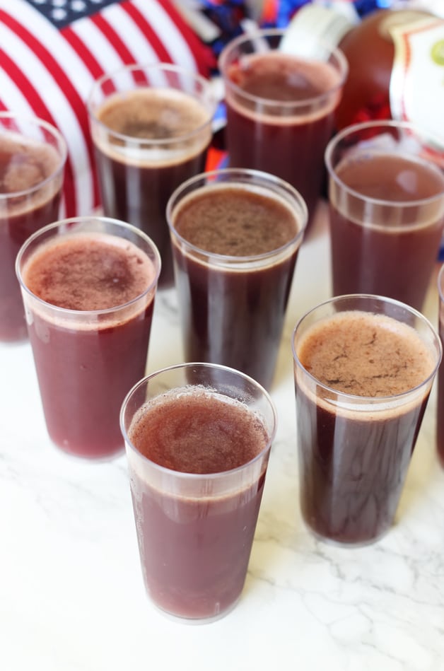 8 glasses of kombucha jello shots standing in rows on a counter.