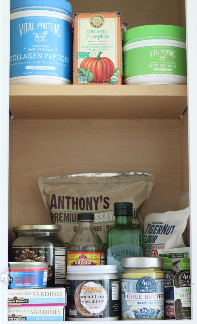 A shot of a pantry containing Cassava flour, apple cider vinegar, olive oil and many other products.