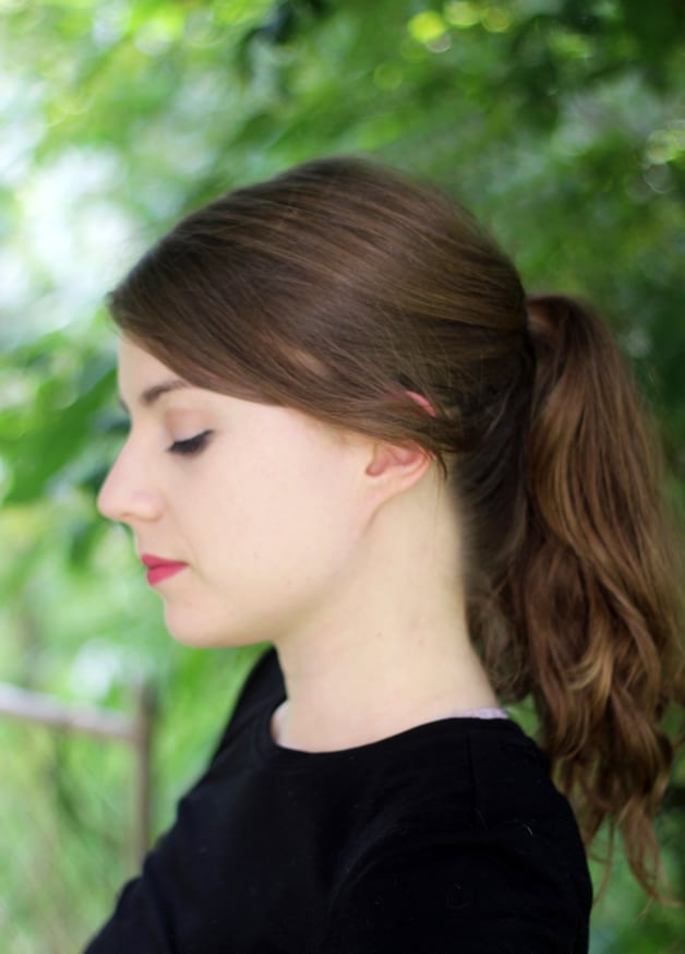 A close up of Michelle from the side while she is looking down.