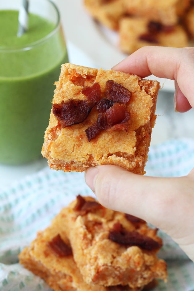 A hand holding a sweet potato bacon bar.