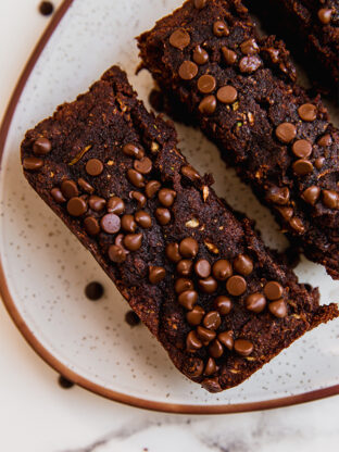 Slices of chocolate zucchini bread on a plate.