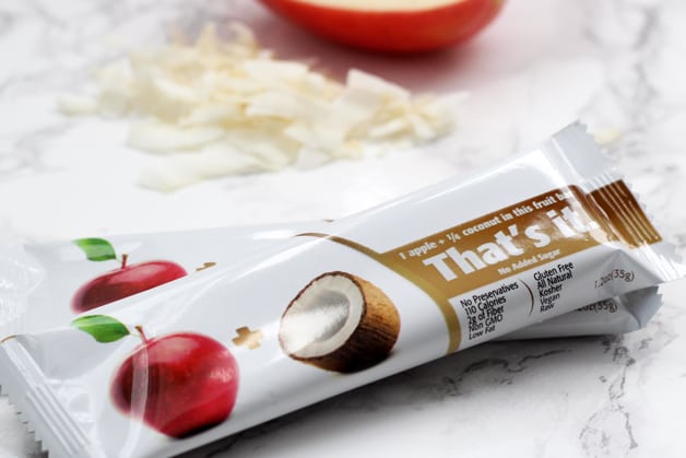 Two coconut apple That\'s Its bars on a counter.