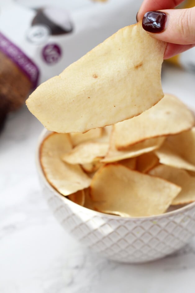 A white bowl filled with cassava chips.