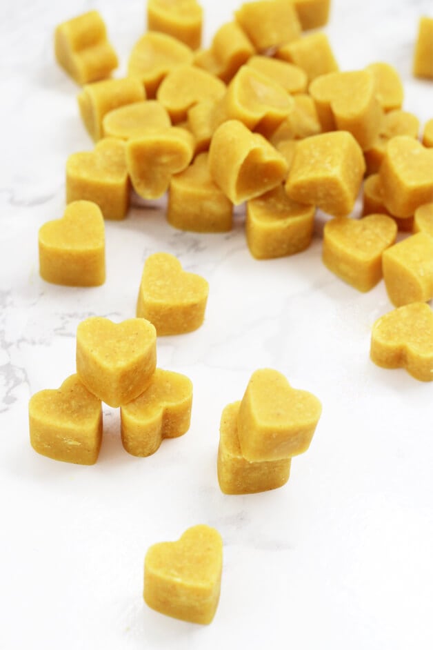 A pile of turmeric chewables in heart shapes. 