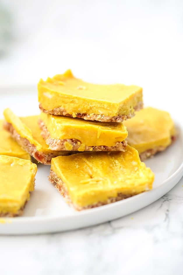 A white plate with seven turmeric bars on it ready to be enjoyed.