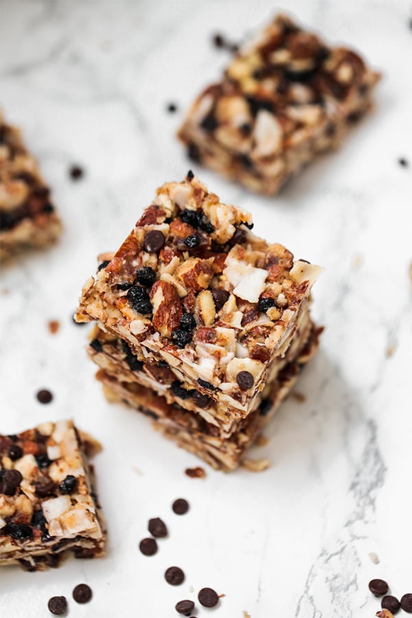 A photo overhead of stack of granola bars with a few pieces scatter around.