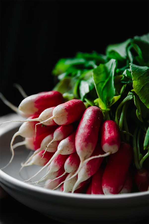 Radishes on a plate with a background