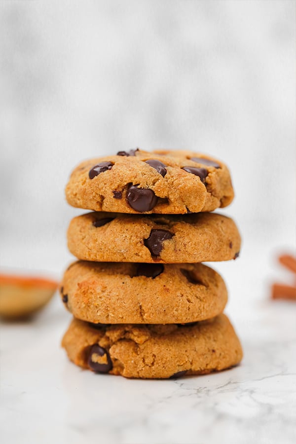 A stack of pumpkin chocolate chip cookies on top of each other.
