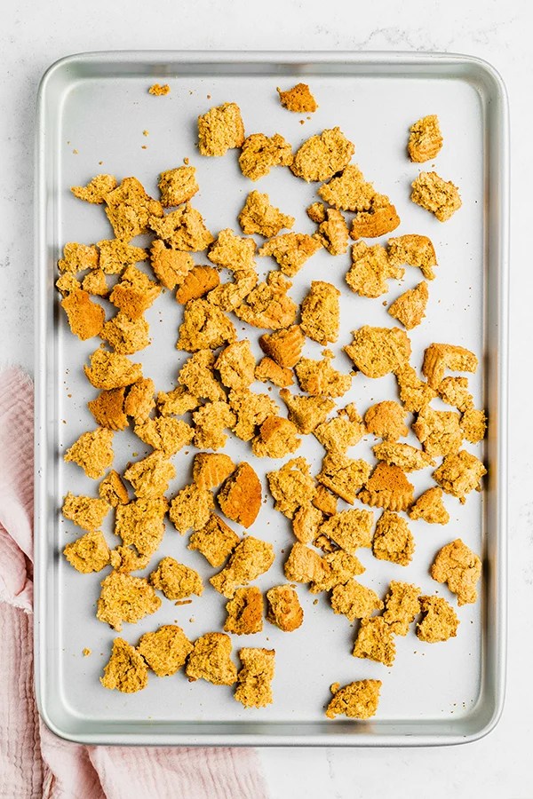 A baking sheet with torn bread.