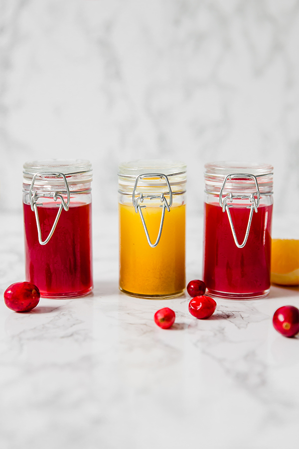 Three glass jars with apple cider vinegar shots