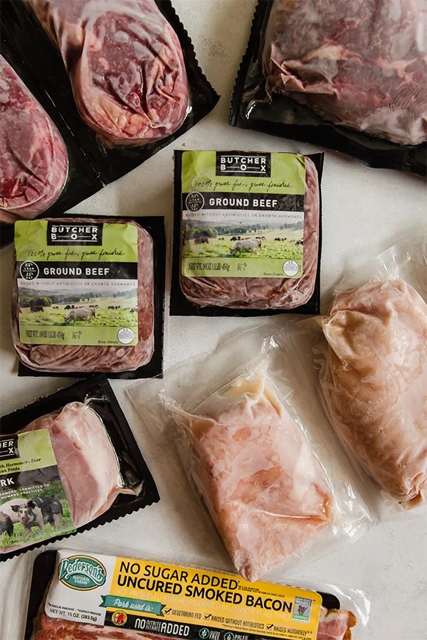 Assorted meats from Butcher Box frozen out on a counter.