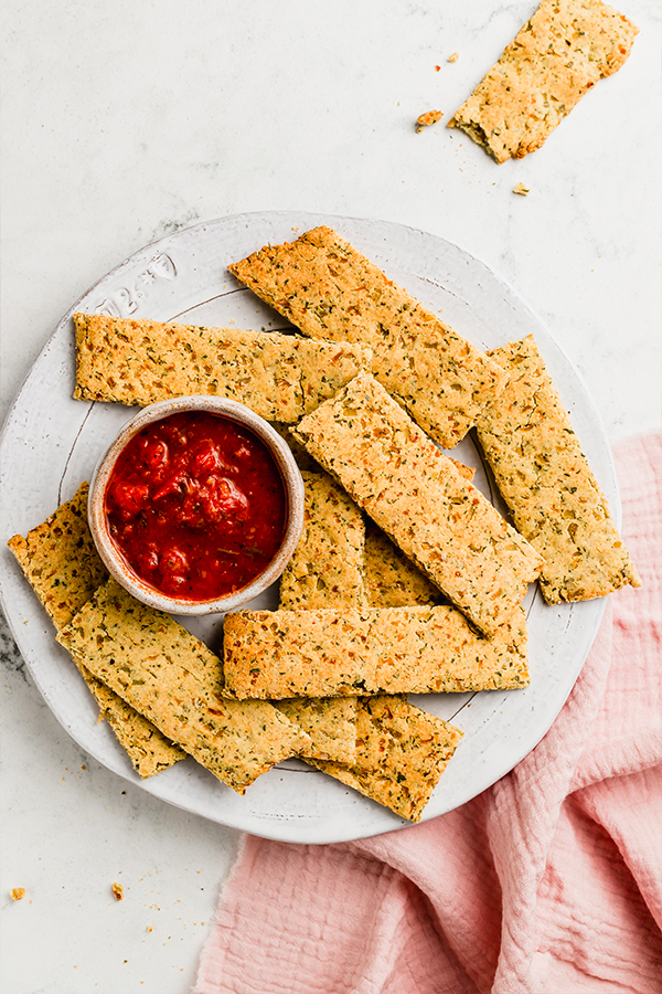 A plate of cauliflower breadsticks and dipping sauce.
