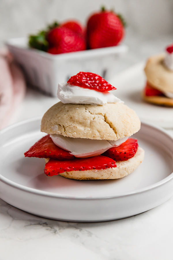A strawberry shortcake on a white plate.
